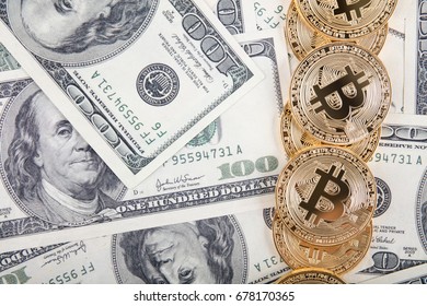 Golden bitcoin coins on us dollars. Close up