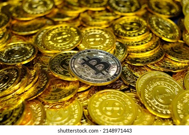 Golden bitcoin cryptocurrency on pile gold coins a lot of
