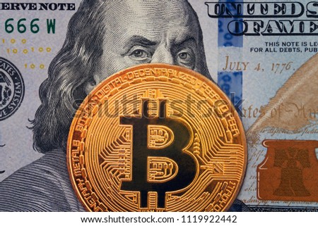 Golden bitcoin with evil, wicked Benjamin Franklin portrait from one hundred american dollars. Business concept of worldwide cryptocurrency, Earnings on cryptocurrency mining.