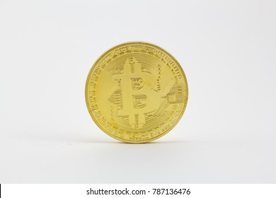 Golden bitcoin isolated in a white background - Shutterstock ID 787136476