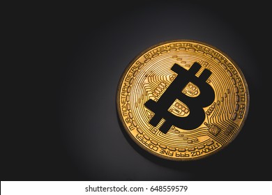 Golden Bitcoin Logo In The Dark