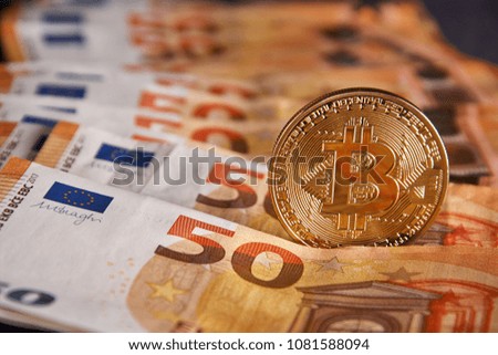 Golden bitcoin on fifty euro banknotes background. Bitcoin crypto currency, Blockchain technology, digital money, Mining concept, bitcoin on 50 euro bill.