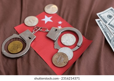 Golden Bitcoins Cryptocurrency with Handcuffs on Dollar bills. Digital crime, arrest or hacking concept. Handcuffs dollars and bitcoins on the table. Not legal mining