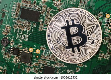 Golden Bitcoins On The Chip. The Green Background. Crypt Of Safety. Virtual Money. Mining. Security.