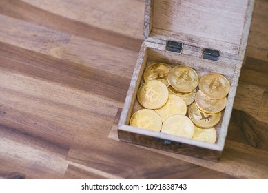 Golden Bitcoins In The Treasure Trove On The Wooden Table.