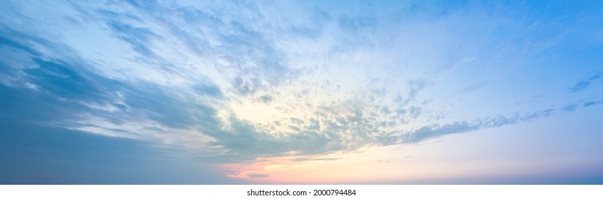 Golden Blick of the sunset on the lilac-blue sky. A sky pattern to replace the sky in the photos. Sunset idyll of calm sky. Natural cloud backrop with gradients and glow. - Shutterstock ID 2000794484