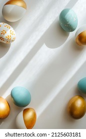 Golden and blue Easter eggs on on white background. Holiday concept.  Happy Easter card with copy space 