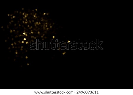 Golden blurred bokeh lights on black background. Glitter sparkle stars for celebrate. Overlay for your design