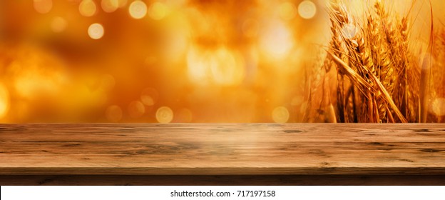 Golden Bokeh Autumn Background With Empty Wooden Table For A Thanksgiving Decoration