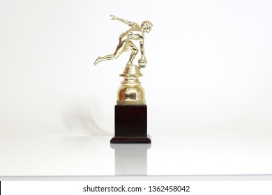 Golden bowling award cup over white background for bowling champion. Gold bowling trophy