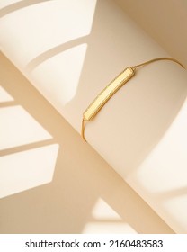 Golden bracelet beige background  Elegant jewelry  Jewelry set minimalist style  Product still life concept