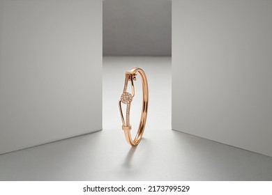 Golden bracelet on white dramatic background with copy space