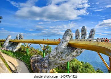 The Golden bridge with many tourist on daytime.Popular landmark on Bana Hills supported by a pair of giant hands and located at a height above sea level at 1,400 meters.Danang,Vietnam.May 28,2019.