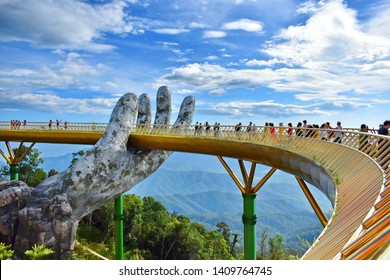 The Golden bridge with many tourist on daytime.Popular landmark on Bana Hills supported by a pair of giant hands and located at a height above sea level at 1,400 meters.Danang,Vietnam.May 28,2019.