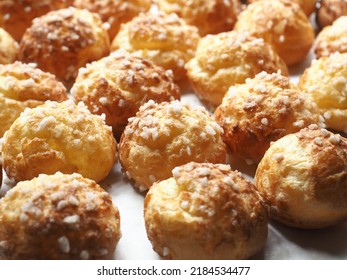 Golden brown baked choux pastry coated with sugar