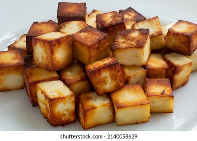 Golden Brown Paneer Or Cottage Cheese Cubes On A White Plate