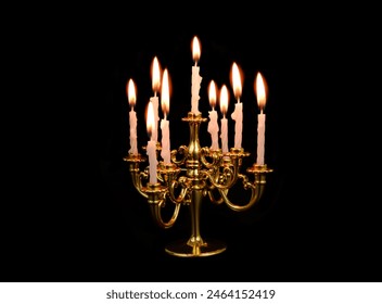 Golden candelabra with many white burning candles isolated on black background. - Powered by Shutterstock