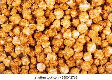 Golden caramel popcorn closeup. Background of popcorn. Snacks and food for a movie