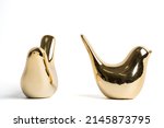 golden ceramic bird on white background