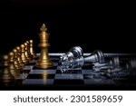 The golden chess king leads the silver chess pieces on the chessboard, business, success, competition,Teamwork and leadership concept.