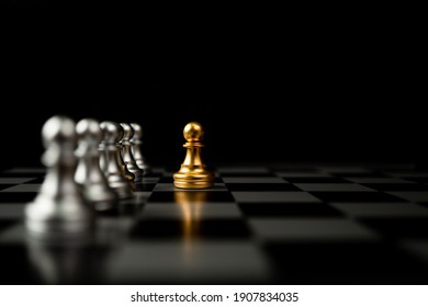 Golden Chess pawn standing in front of other chess, Concept of a leader must have courage and challenge in the competition, leadership and business vision for a win in business games - Powered by Shutterstock