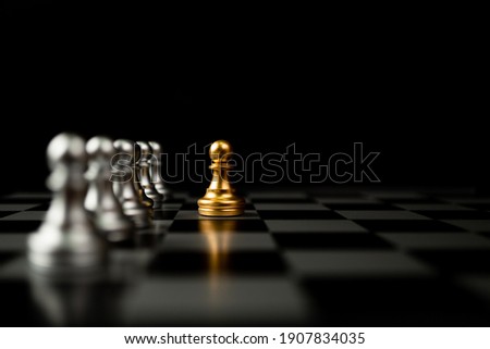 Golden Chess pawn standing in front of other chess, Concept of a leader must have courage and challenge in the competition, leadership and business vision for a win in business games