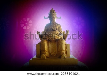 Golden Chinese god of wealth under mysterious surrounding light and colors with power.