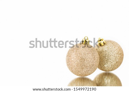 Golden Christmas balls are reflected in the mirror surface. Concept greeting card background Christmas and New year. selective focus. Copy space for text