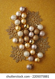 Golden Christmas Balls, Golden Snowflakes On Sparkling Yellow Background. Flat Lay, Top View, Copy Space. Christmas Frame, Christmas Banner Mockup.