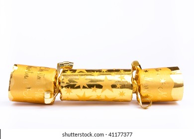 Golden Christmas Cracker Isolated Against White Background.