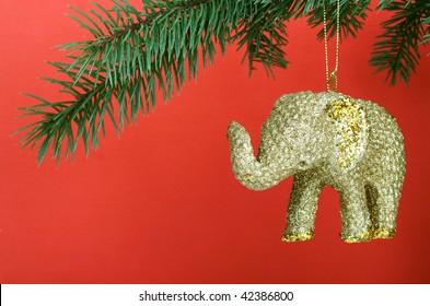 Golden Christmas elephant on red background