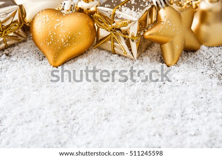 Image, Stock Photo Golden Christmas ornaments on snow background