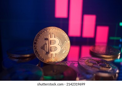 Golden coins with bitcoin logo drop at bear market. Pullback of leader cryptocurrency Bitcoin BTC in trading. Decentralized digital currency fell. Crypto collapse. Electronic money on black background