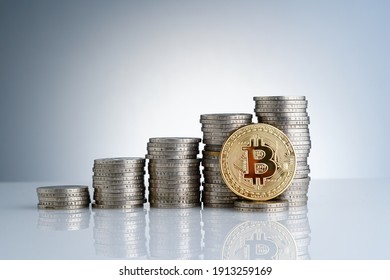Golden coins with bitcoin symbol on a stack of coins over white background. 