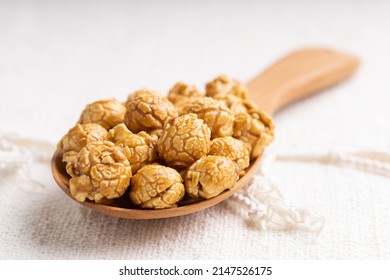 Golden Color Caramel Popcorn In Wooden Ladle, Crunchy And Sweet Dessert