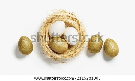 Golden color eggs in nest from straw on white background. Stylish gold egg for easter spring holiday. Top view decorative shiny Easter eggs minimal style card with copy space.