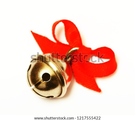 Golden color jingle bell with red ribbon isolated on a white backgrounds