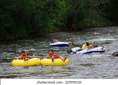 GOLDEN, COLORADO - July 25, 2015 - People Inner Tubing Down Clear Creek To Cool Off From The Summer Heat