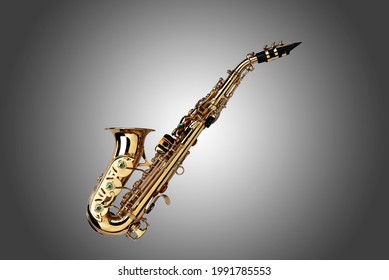 Golden colored saxophone on grey gradient background