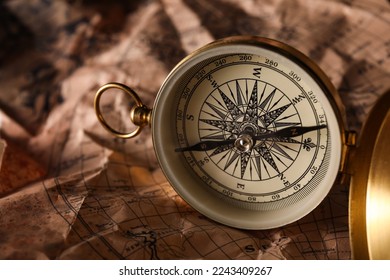 Golden compass on world map, closeup - Shutterstock ID 2243409267