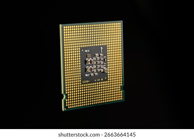 Golden computer processor chip displayed against a dark background, highlighting details of its design and connectors. Ideal for technology, computing, or data-themed applications.