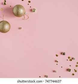 Golden Confetti And Christmas Toy Balls On Pink Background. Flat Lay, Top View Holiday Background.