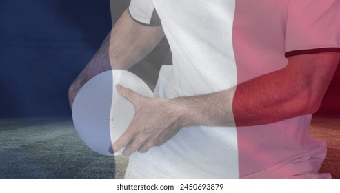 Golden confetti and france waving flag against caucasian male rugby player holding a rugby ball. sports and competition concept - Powered by Shutterstock