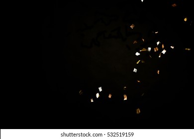 Golden Confetti Isolated On Black Background