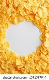 Golden cornflakes on full frame with empty white space. Healthy breakfast
