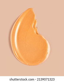 Golden cosmetic illuminating bronzer highlighter tan face body gel smudge on beige background - Shutterstock ID 2139071323