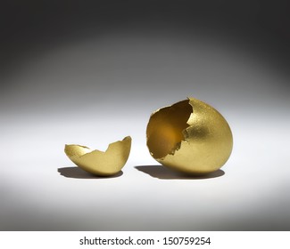 A Golden Cracked Egg Shell In A Spotlight.