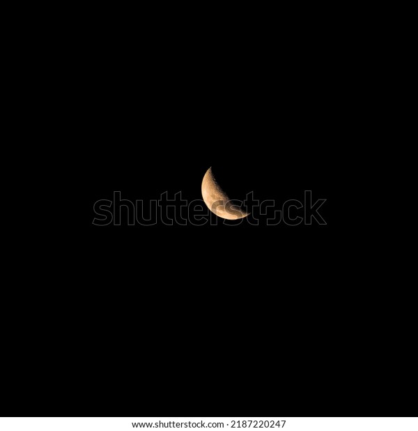 Golden crescent moon (up\
to Crescent Quarter), isolated in a black sky in the southern\
hemisphere.