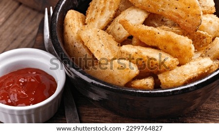 Golden Crisps: Top-View Close-up of Potato Wedges with Tomato Ketchup, An Irresistible Snack
