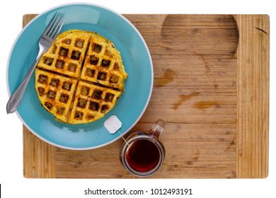 Golden Crispy Fried Hash Brown With Honey Comb Waffle Pattern On A Blue Plate With A Teabag Steeping In A Mug Of Hot Water Alongside In An Overhead View On A Wooden Board With Copy Space